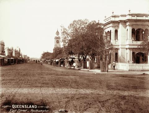 View of East Street, Rockhampton featuring the Post Office and horses